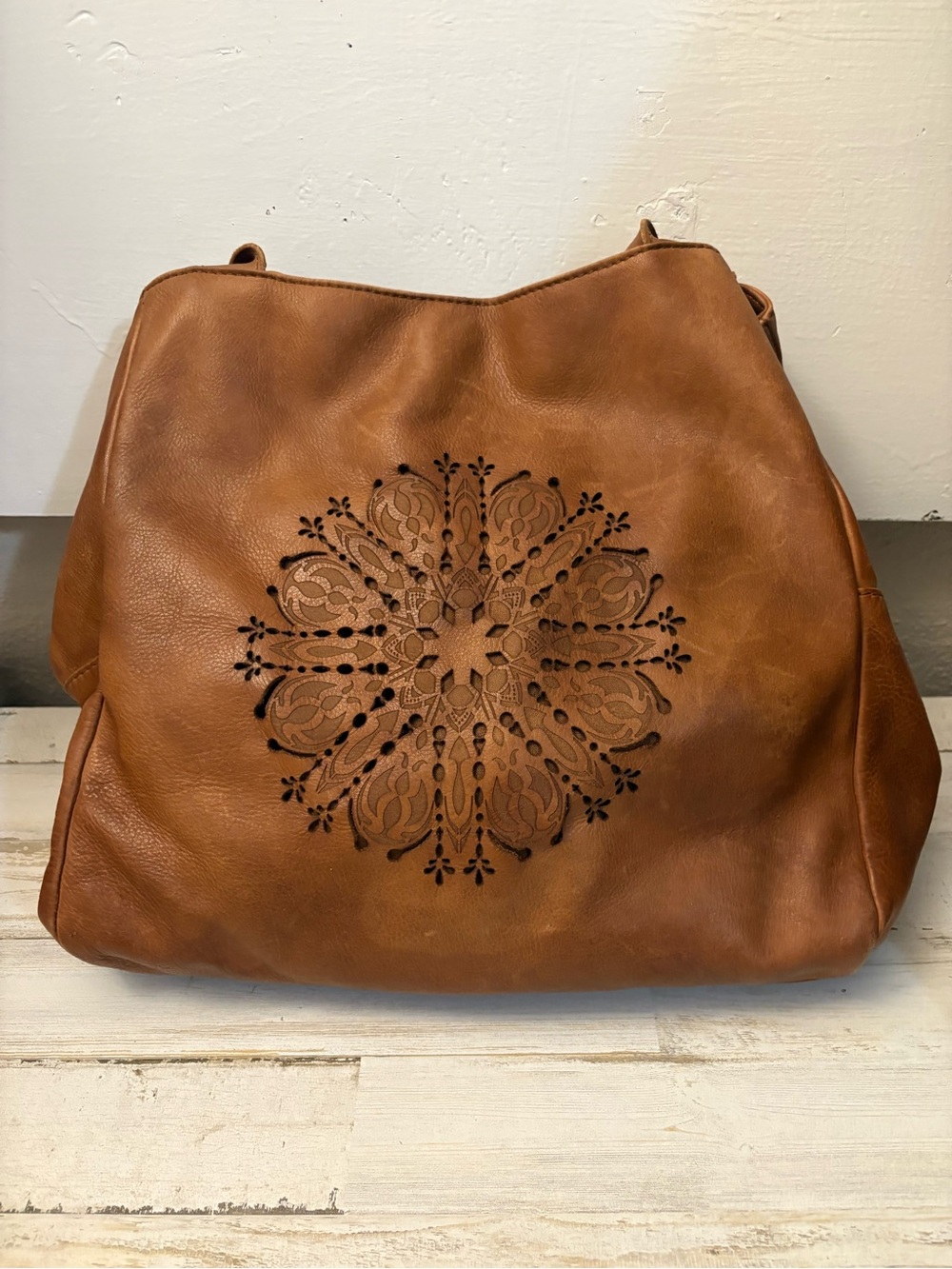 Boho brown 100% leather slouchy bag with laser-cut mandala design on front
